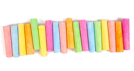 colorful pieces of chalk isolated on white background, top view