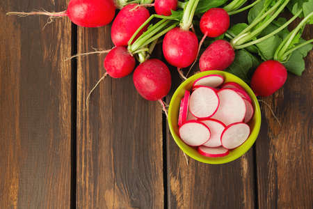 fresh radish isolated on wooden background, top view