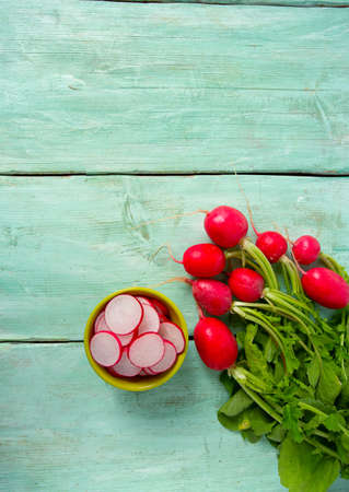 fresh radish isolated on wooden backgroundの写真素材