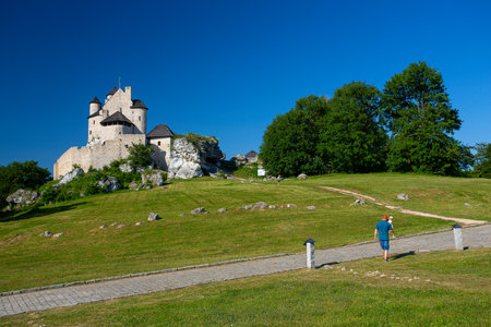 Bobolice Castle - 14th-century royal castle in the village of Bobolice, Polish Jura, Poland. Family is exploring surroundings of the castle.のeditorial素材