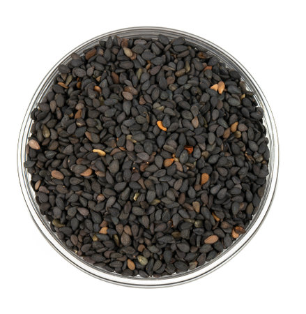 Black sesame seeds in a glass bowl isolated on white background. Top view.の写真素材