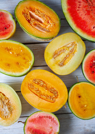 Variety of melons and water melons on wooden surface. Food backgrounds. Top view.の写真素材