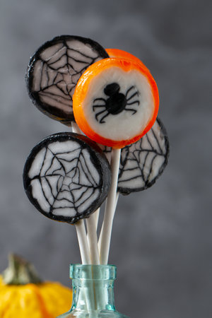 Colorful halloween candies on grey stone surfaceの写真素材
