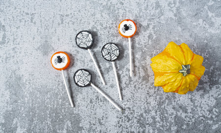 Colorful halloween candies on grey stone surface, top view and empty space for your textの写真素材