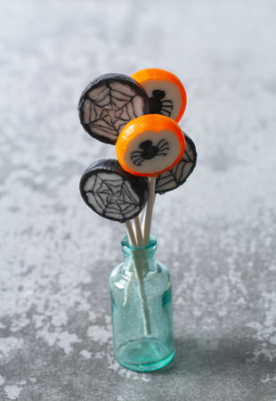 Colorful halloween candies on grey stone surfaceの写真素材