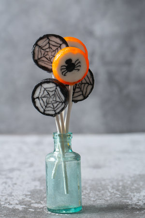Colorful halloween candies on grey stone surfaceの写真素材
