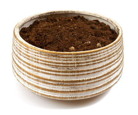 Ceramic pot with a soil ready for a new plant, isolated on white background.の写真素材
