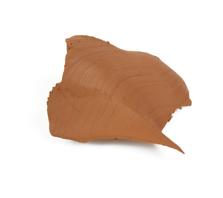 Natural clay piece isolated on white background. Wet clay material for sculpting or modeling.の写真素材