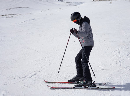 Skier skiing downhill on fresh powder snow at sunny winter day.の写真素材