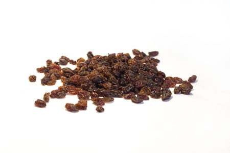 raisin is a delicious dried fruit. dry grapes scattered on the table. on white background isolatedの写真素材