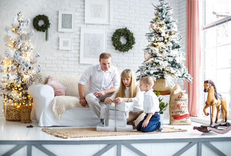 the family is preparing for the new year. found gifts under the tree. preparation for Christmas. holiday decorationsの写真素材