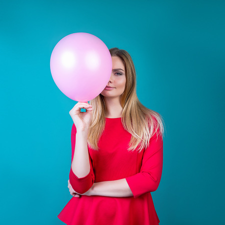 beautiful girl with balls on a bright background a party hardの写真素材