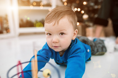 the little boy is playing in the designer. children's games at home. intellectual development of modern children. problems of raising small boys happy lifeの写真素材