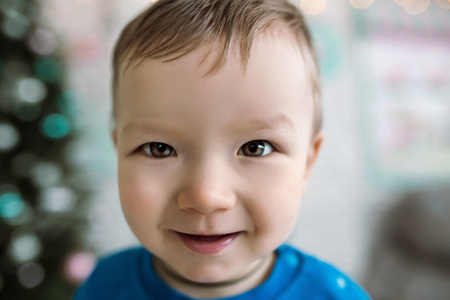 a large portrait of a little boy. cheerful rebeon smiles into the camera. happy children lifeの写真素材