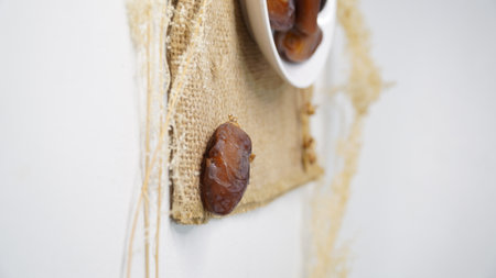 Dates have a distinctive taste with a chewy texture in the flesh. on the background is a brown bag...