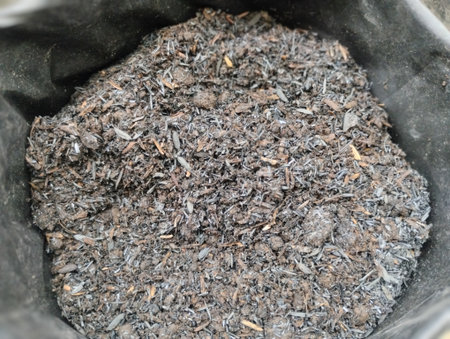 Close-up view of an organic potting mix containing charcoal fragments, compost, and natural fibers. The textured soil blend is suitable for gardening, seed starting, and plant cultの写真素材
