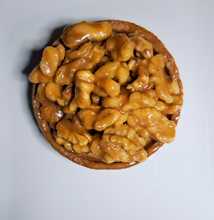 Walnuts on a plate on a white background. Top view.