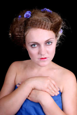Shy woman with flowers in hair