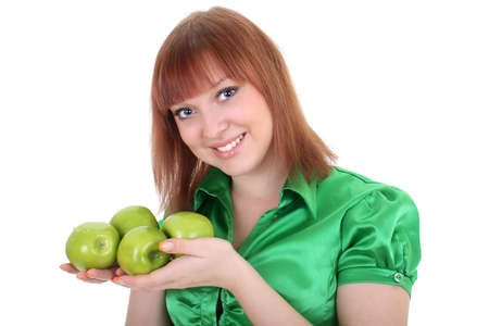 young attractive red-haired woman with green apples isolated over white backgroundの写真素材