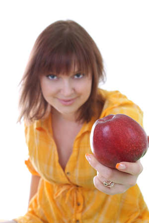 young attractive woman with red apple over white. apple in focusの写真素材