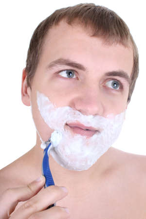 young man shaving with razor isolated over whiteの写真素材