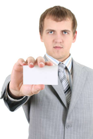Young businessman showing a blank business card over whiteの写真素材