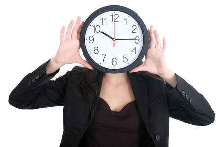 Businesswoman in suit holding a clock over whiteの写真素材