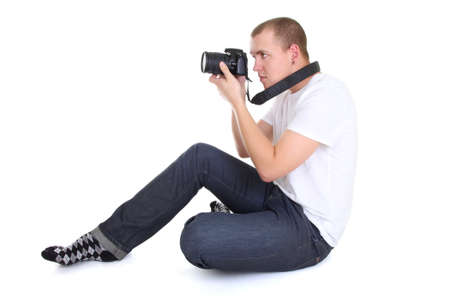man with dslr camera sitting over whiteの写真素材