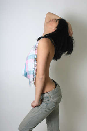 Sexy brunette woman with scarf over grey