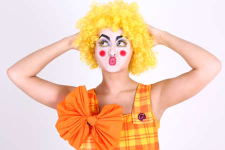 Funny clown in costume with bow and make-upの写真素材