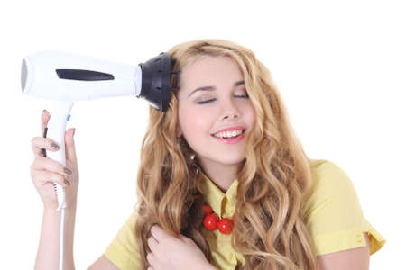 attractive girl with long curly hair and hairdryer in her handの写真素材