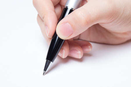 female hand writing over white backgroundの写真素材