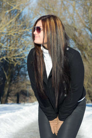 young attractive brunette in winter parkの写真素材