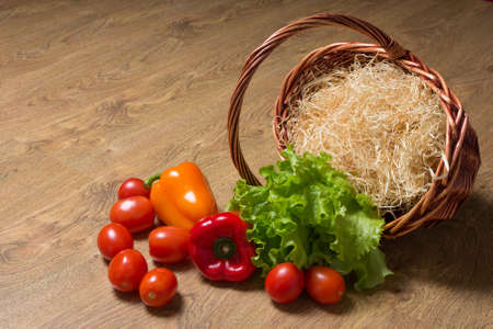 vegetables and wooden basket on the tableの写真素材