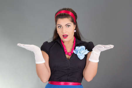 surprised brunette woman in retro clothes over grey