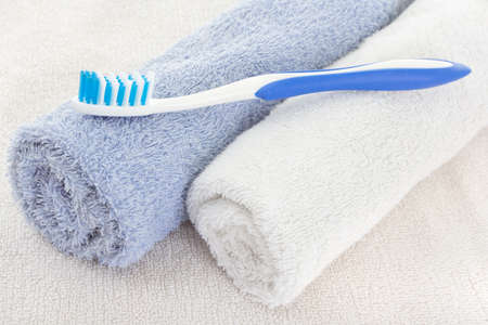 Blue toothbrush over fresh white towels