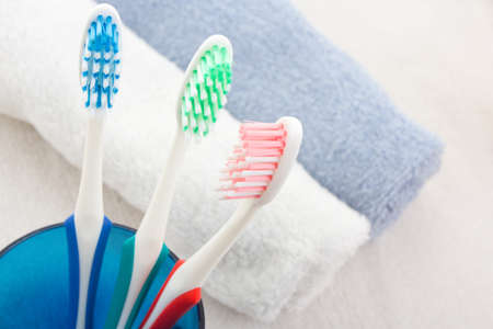 Colorful soft toothbrushes and blue towelの写真素材