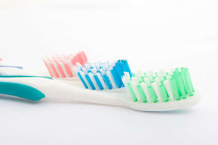 Red, green and blue toothbrush over whiteの写真素材
