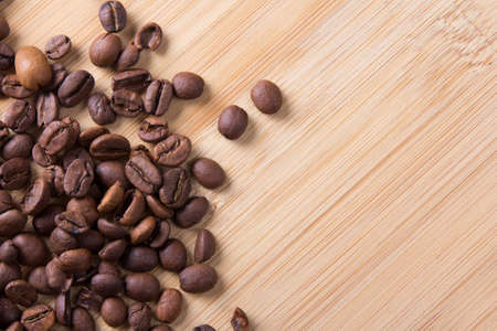 brown coffee beans over wooden backgroundの写真素材