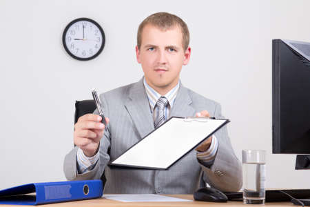 businessman giving a pen to sign a contractの写真素材