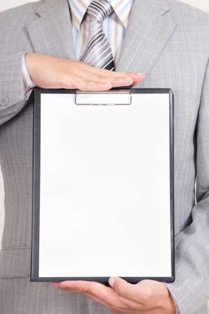 sheet of white paper in business man handsの写真素材