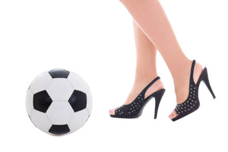 sexy female legs on heels and soccer ball over white backgroundの写真素材