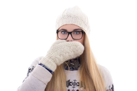 teenage girl with beautiful long hair in warm winter clothes closing her mouth isolated on white backgroundの写真素材