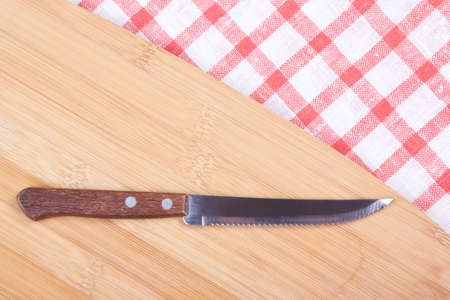 kitchen knife on the table with checkered tableclothの写真素材