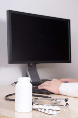 pills and doctor pharmacist working in his officeの写真素材