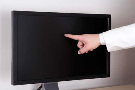 male hand and big black flat touchscreen