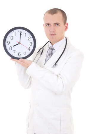 young male doctor holding clock isolated on white backgroundの写真素材