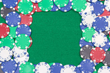 frame with colorful poker chips on the green casino tableの写真素材