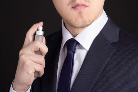 close up of handsome young business man using perfumeの写真素材