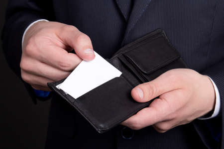 purse with blank visiting card in business man handの写真素材